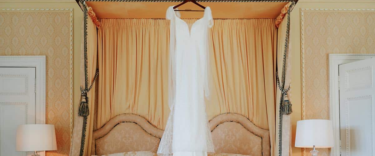 Scottish wedding dress, bridal dress hanging from the bed,